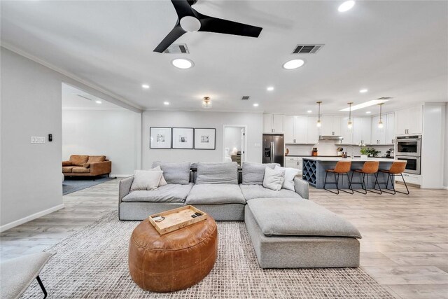 203 Sailors Run, Lakeway, TX 78734 - living room with ceiling fan, light wood finished floors, recessed lighting, and crown molding
