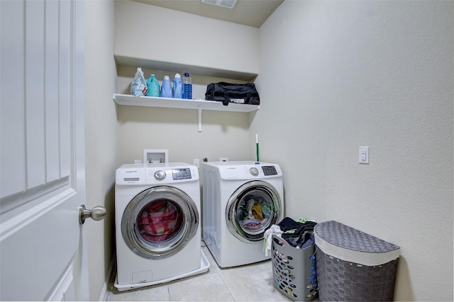 417 Epiphany Ln, Pflugerville, TX 78660 - laundry room with washing machine and clothes dryer and tile patterned floors
