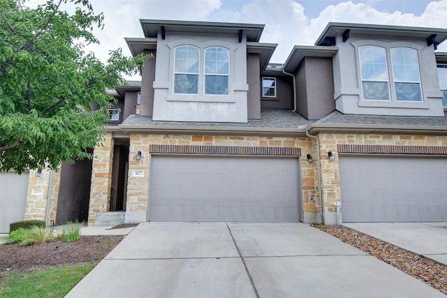 417 Epiphany Ln, Pflugerville, TX 78660 - townhome / multi-family property featuring a garage, stone siding, stucco siding, and concrete driveway