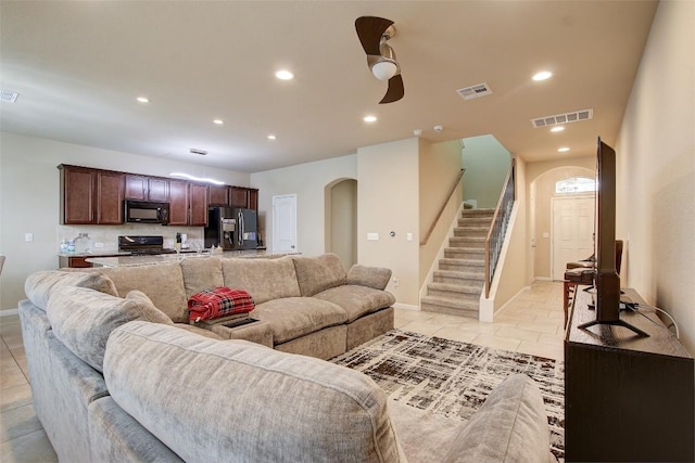 417 Epiphany Ln, Pflugerville, TX 78660 - living area with arched walkways, stairway, recessed lighting, light tile patterned floors, and a ceiling fan