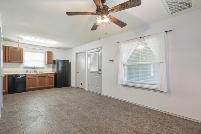 17737 Golden Valley Dr, Manor, TX 78653 - kitchen with black appliances, light countertops, brown cabinets, and a ceiling fan