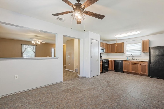 17737 Golden Valley Dr, Manor, TX 78653 - kitchen featuring black appliances, ceiling fan, light countertops, and brown cabinetry