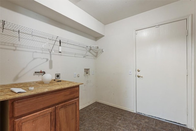 17737 Golden Valley Dr, Manor, TX 78653 - laundry area with electric dryer hookup, hookup for a washing machine, and dark tile patterned floors