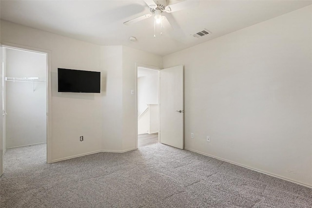 17737 Golden Valley Dr, Manor, TX 78653 - unfurnished bedroom featuring a spacious closet, carpet flooring, a closet, and a ceiling fan