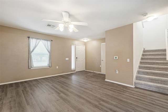 17737 Golden Valley Dr, Manor, TX 78653 - unfurnished living room with wood finished floors, a ceiling fan, and stairs