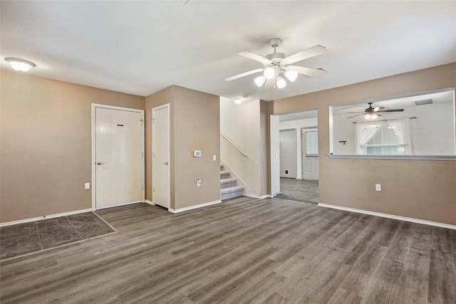 17737 Golden Valley Dr, Manor, TX 78653 - unfurnished living room featuring ceiling fan, wood finished floors, and stairs