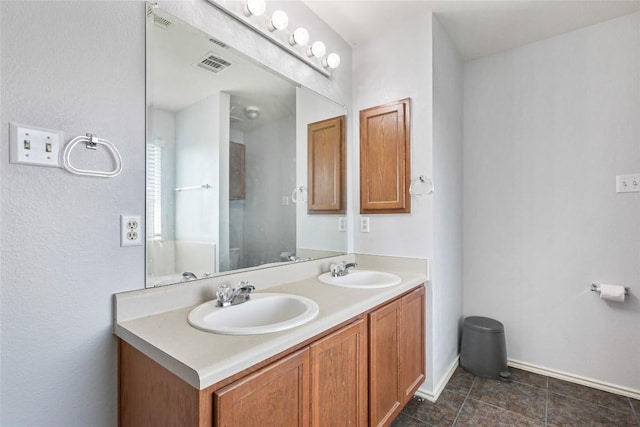 17737 Golden Valley Dr, Manor, TX 78653 - bathroom featuring double vanity and tile patterned floors