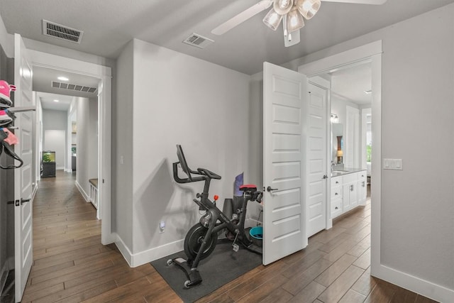205 Honey Locust Cv, Leander, TX 78641 - exercise room with dark wood-style floors, ceiling fan, and recessed lighting