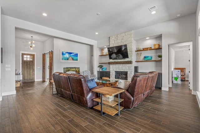 205 Honey Locust Cv, Leander, TX 78641 - living area with a stone fireplace, dark wood finished floors, and recessed lighting