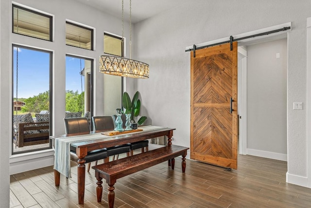 205 Honey Locust Cv, Leander, TX 78641 - dining room featuring a barn door and wood finished floors