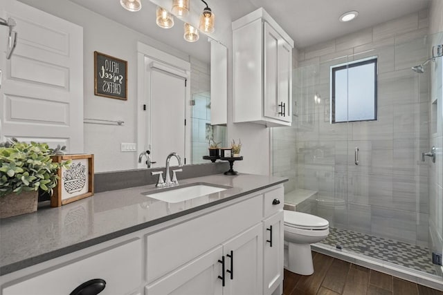 205 Honey Locust Cv, Leander, TX 78641 - bathroom featuring vanity, a shower stall, wood finished floors, and recessed lighting