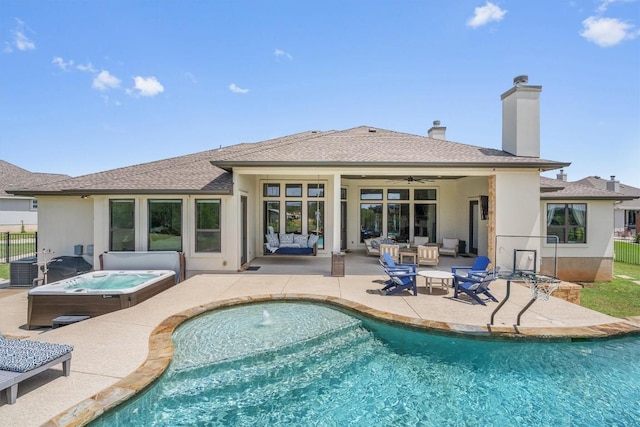205 Honey Locust Cv, Leander, TX 78641 - rear view of house with an outdoor hot tub, a ceiling fan, outdoor lounge area, stucco siding, and a patio