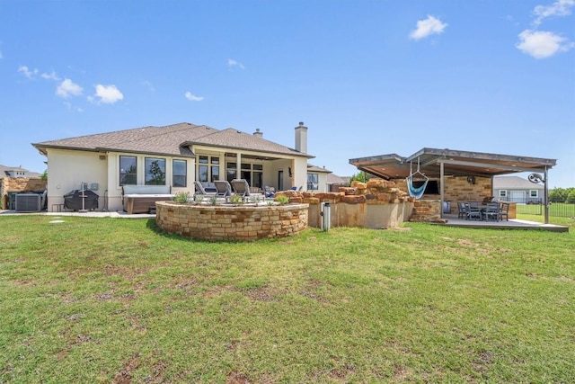 205 Honey Locust Cv, Leander, TX 78641 - back of property featuring a patio area, ceiling fan, a lawn, stucco siding, and a chimney