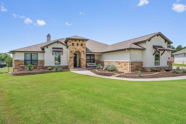 205 Honey Locust Cv, Leander, TX 78641 - view of front of house featuring stone siding, stucco siding, a chimney, and roof with shingles
