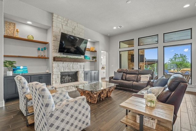 205 Honey Locust Cv, Leander, TX 78641 - living room featuring a fireplace, dark wood-style flooring, and recessed lighting