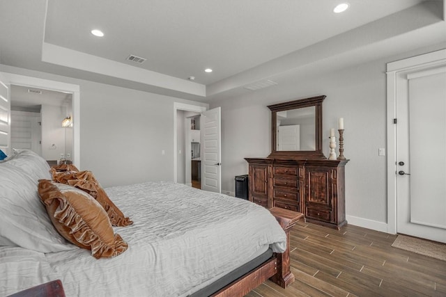 205 Honey Locust Cv, Leander, TX 78641 - bedroom with a tray ceiling, recessed lighting, and dark wood finished floors