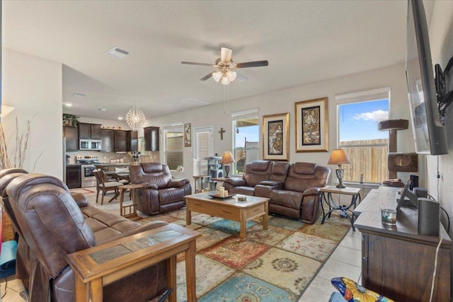 212 Plata Ln, Jarrell, TX 76537 - living room featuring a ceiling fan, a chandelier, and light tile patterned floors