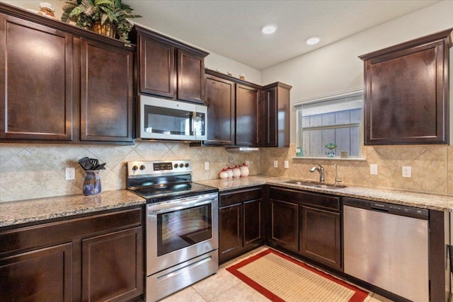 212 Plata Ln, Jarrell, TX 76537 - kitchen with stainless steel appliances, backsplash, and light stone countertops