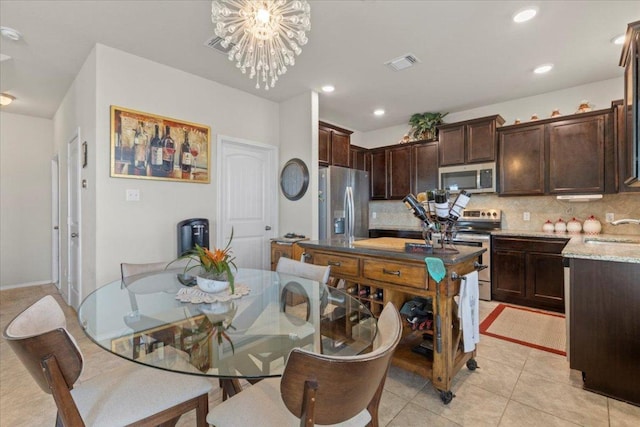 212 Plata Ln, Jarrell, TX 76537 - dining space featuring light tile patterned floors, recessed lighting, and a chandelier