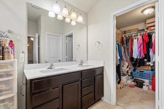 212 Plata Ln, Jarrell, TX 76537 - bathroom featuring double vanity and a spacious closet