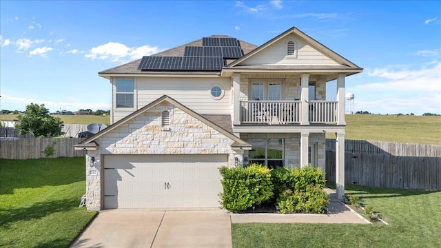 212 Plata Ln, Jarrell, TX 76537 - view of front of house with a balcony, stone siding, roof mounted solar panels, concrete driveway, and roof with shingles