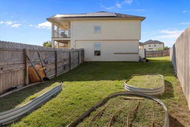 212 Plata Ln, Jarrell, TX 76537 - rear view of property with solar panels, a balcony, and a fenced backyard