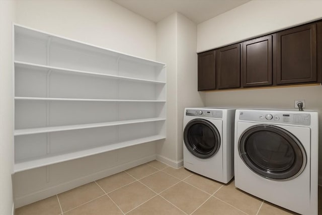 212 Plata Ln, Jarrell, TX 76537 - washroom with cabinet space, washer and dryer, and light tile patterned floors