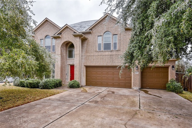 903 Fork Ridge Path, Round Rock, TX 78665 - view of front of home featuring an attached garage, concrete driveway, and brick siding