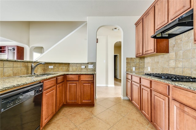 903 Fork Ridge Path, Round Rock, TX 78665 - kitchen featuring black dishwasher, under cabinet range hood, gas stovetop, and light stone counters