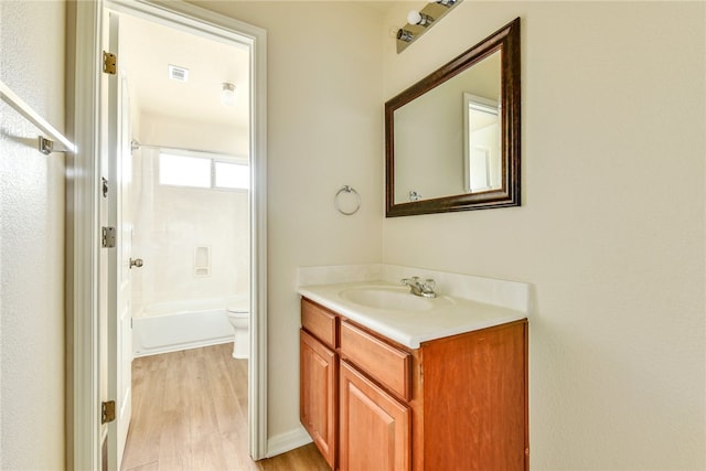 903 Fork Ridge Path, Round Rock, TX 78665 - bathroom featuring vanity, wood finished floors, and  shower combination
