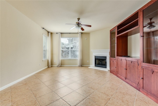 903 Fork Ridge Path, Round Rock, TX 78665 - unfurnished living room with a ceiling fan, light tile patterned flooring, and a fireplace with raised hearth