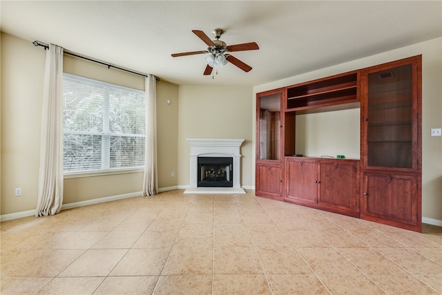 903 Fork Ridge Path, Round Rock, TX 78665 - unfurnished living room featuring a ceiling fan, light tile patterned flooring, and a fireplace with raised hearth
