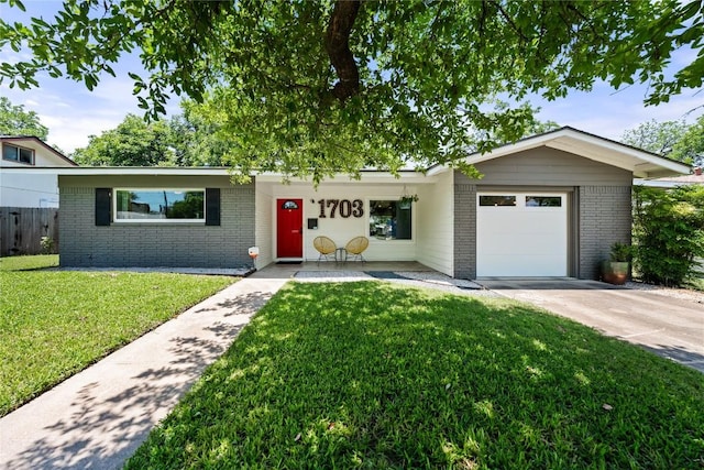 1703 Duke Ave, Austin, TX 78757 - ranch-style house featuring brick siding, a garage, and concrete driveway