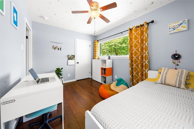 1703 Duke Ave, Austin, TX 78757 - bedroom with dark wood-style flooring, a desk, and a ceiling fan