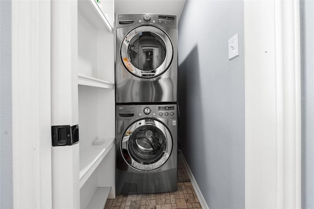 1703 Duke Ave, Austin, TX 78757 - washroom with stacked washer / drying machine and stone finish flooring