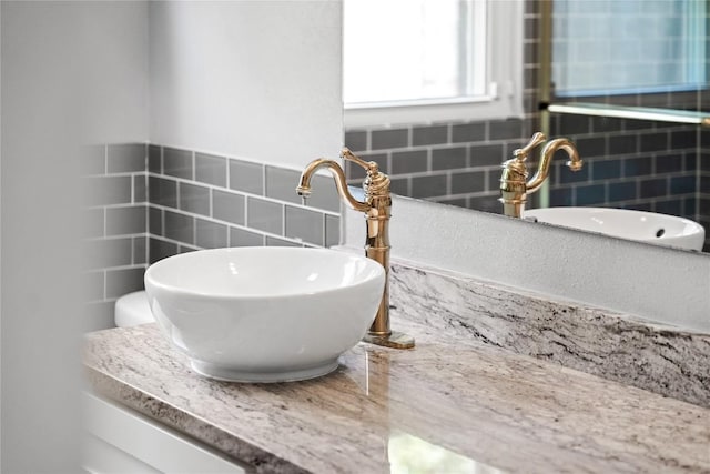 1703 Duke Ave, Austin, TX 78757 - bathroom with tile walls, decorative backsplash, and vanity
