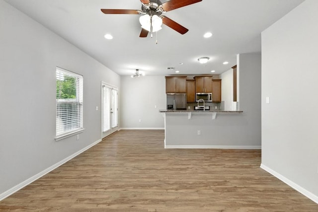 7202 Redding Dr Unit 203, Austin, TX 78745 - unfurnished living room with recessed lighting, light wood-style floors, and a ceiling fan