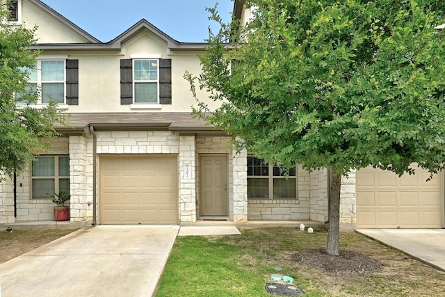 7202 Redding Dr Unit 203, Austin, TX 78745 - view of front of house featuring concrete driveway, stucco siding, stone siding, and a garage