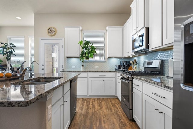 2302 Dillon Pond Ln Unit A, Pflugerville, TX 78660 - kitchen featuring stainless steel appliances, plenty of natural light, backsplash, white cabinets, and recessed lighting