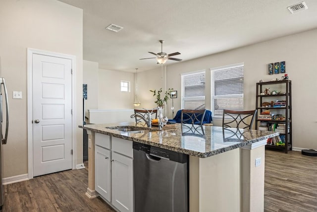 2302 Dillon Pond Ln Unit A, Pflugerville, TX 78660 - kitchen featuring stainless steel dishwasher, a ceiling fan, a center island with sink, dark wood-type flooring, and stone counters