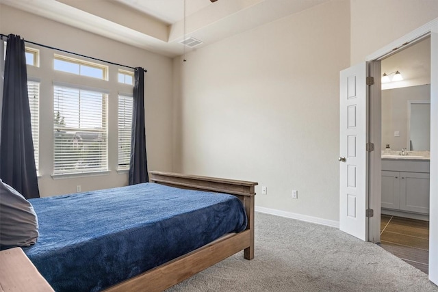 2302 Dillon Pond Ln Unit A, Pflugerville, TX 78660 - carpeted bedroom featuring ensuite bathroom and baseboards