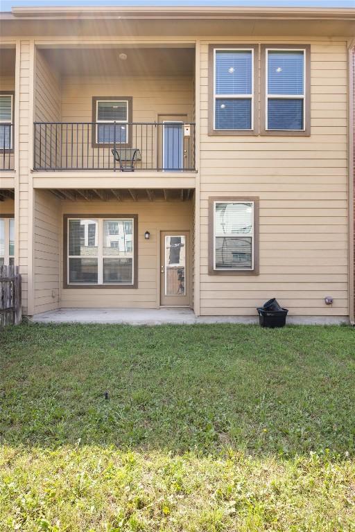 2302 Dillon Pond Ln Unit A, Pflugerville, TX 78660 - back of property featuring a balcony, a lawn, and a patio