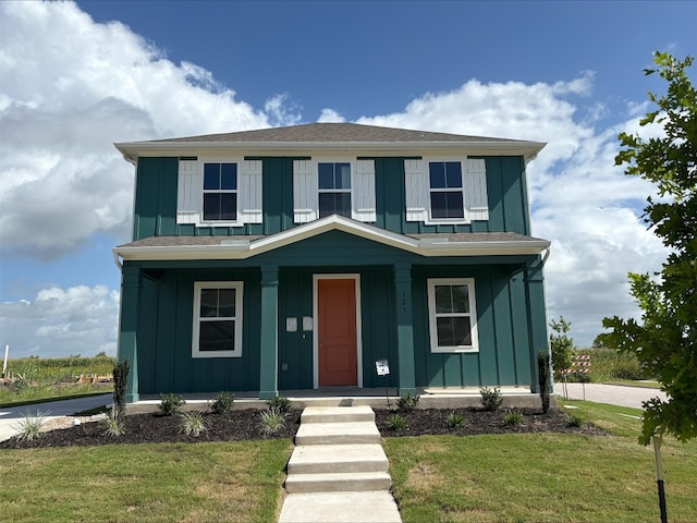 123 Elm Branch Trl, Taylor, TX 76574 - view of front facade featuring board and batten siding, covered porch, and a front lawn