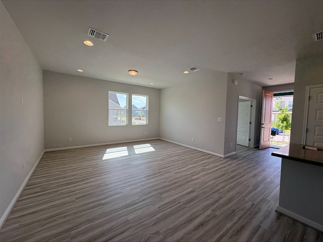 123 Elm Branch Trl, Taylor, TX 76574 - spare room featuring plenty of natural light, dark wood-style floors, and recessed lighting