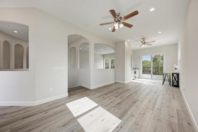 13201 Mansfield Dr, Austin, TX 78732 - empty room with wood finished floors, ceiling fan, recessed lighting, and arched walkways