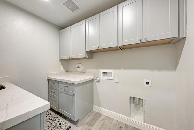 13201 Mansfield Dr, Austin, TX 78732 - washroom featuring cabinet space, light wood-type flooring, hookup for an electric dryer, and hookup for a washing machine