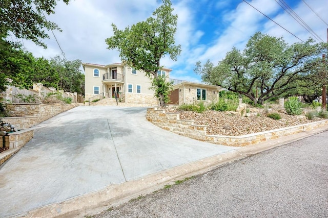 13201 Mansfield Dr, Austin, TX 78732 - mediterranean / spanish-style home with a balcony, stone siding, and stucco siding