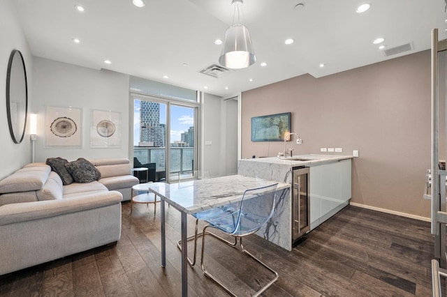 200 Congress Ave Unit 33Bb, Austin, TX 78701 - kitchen featuring wine cooler, dark wood-type flooring, pendant lighting, a peninsula, and open floor plan