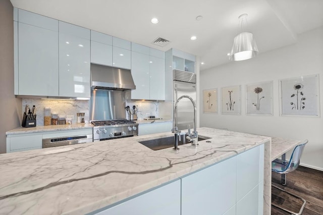 200 Congress Ave Unit 33Bb, Austin, TX 78701 - kitchen with ventilation hood, stainless steel gas stove, dark wood-type flooring, modern cabinets, and backsplash