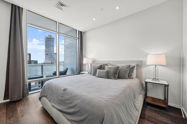 200 Congress Ave Unit 33Bb, Austin, TX 78701 - bedroom with expansive windows, hardwood / wood-style flooring, a city view, and recessed lighting